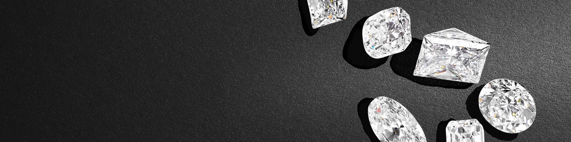 Image shows large multiple diamond cuts on a black textured background.